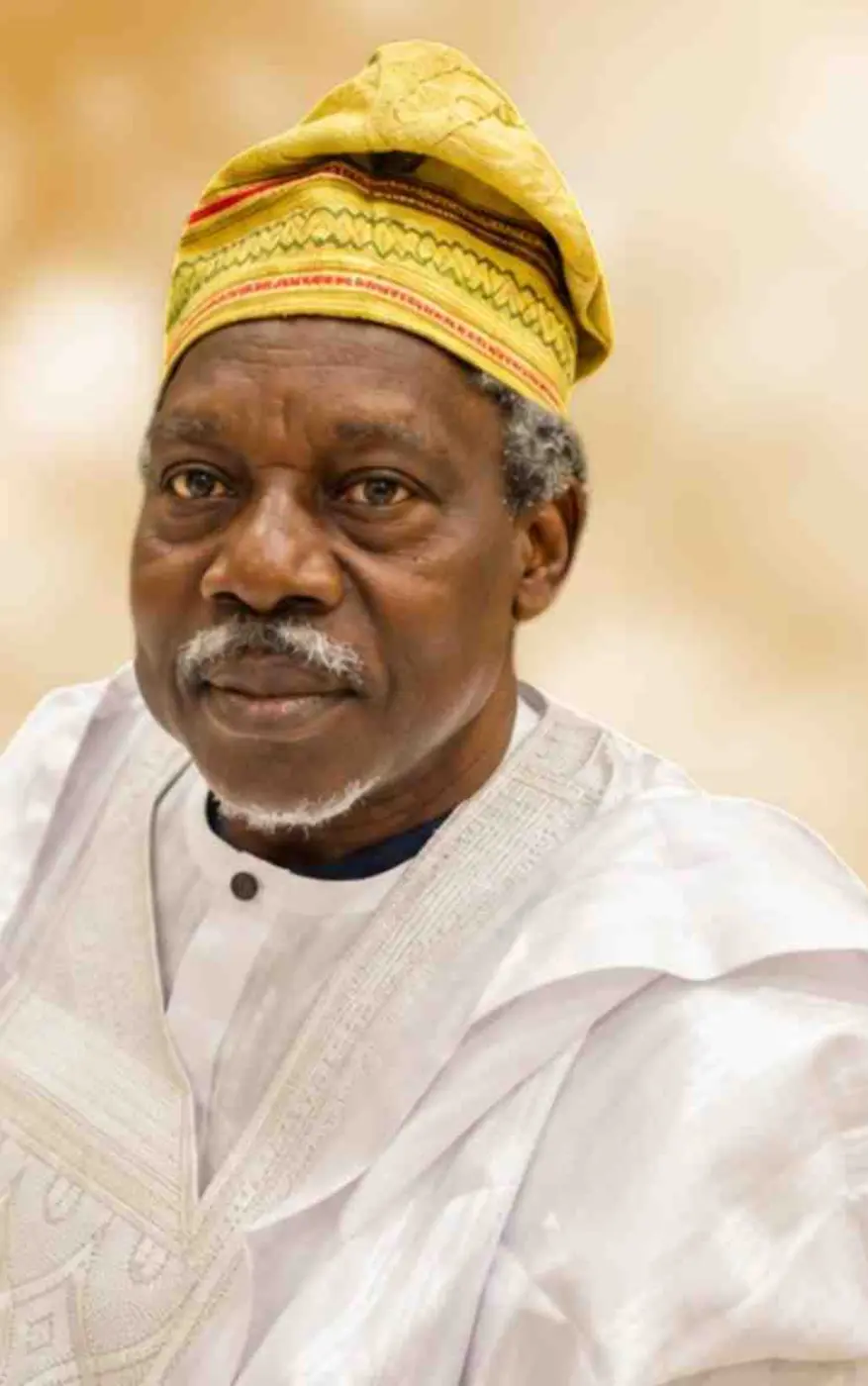 Portrait of Clement Ayodeji Olusola Oroge in a white agbada and gold cap